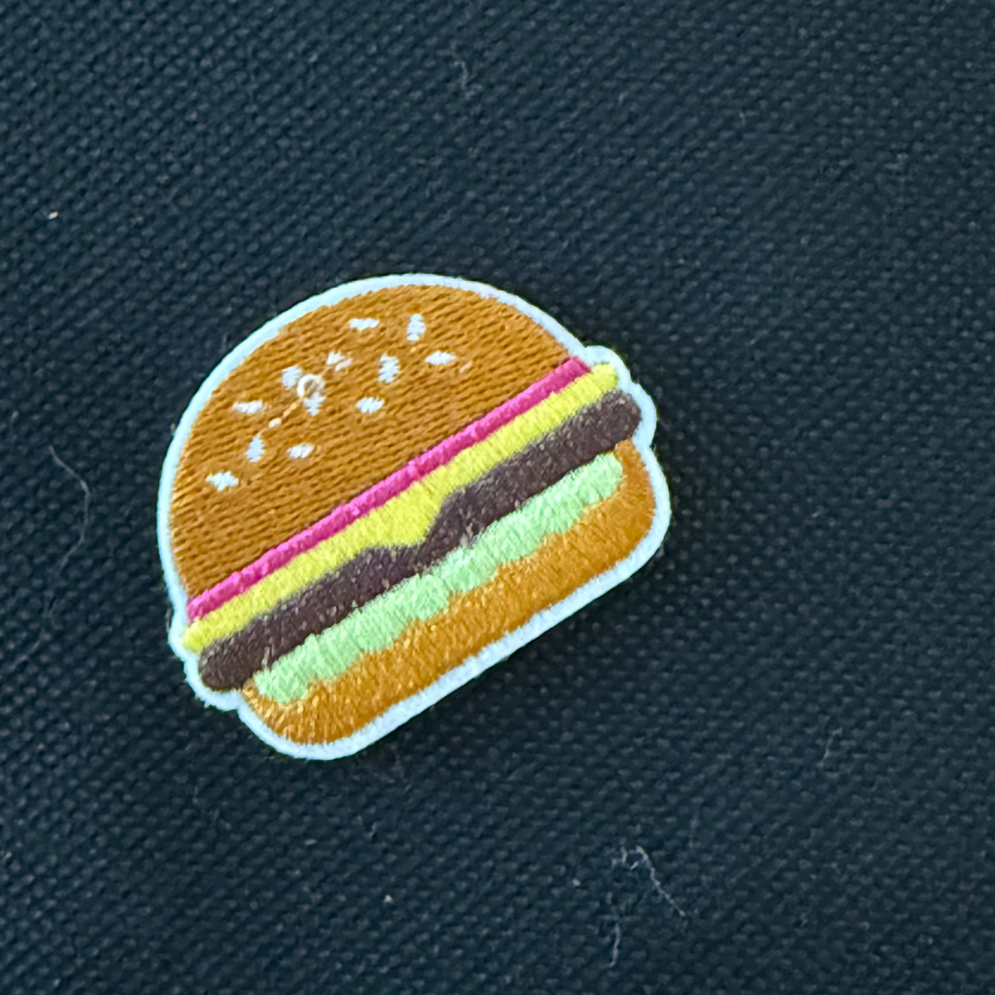Hamburger patch on a dark fabric background