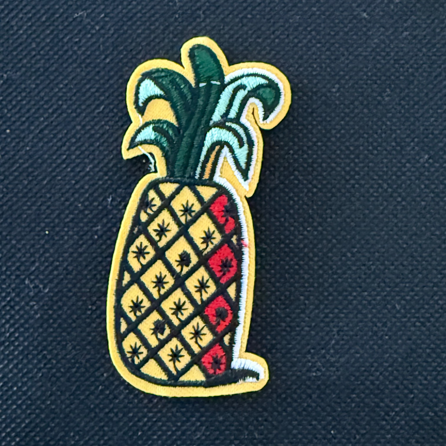 Pineapple patch on a dark blue fabric background