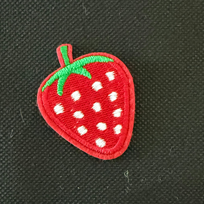 Embroidered strawberry patch on a black background