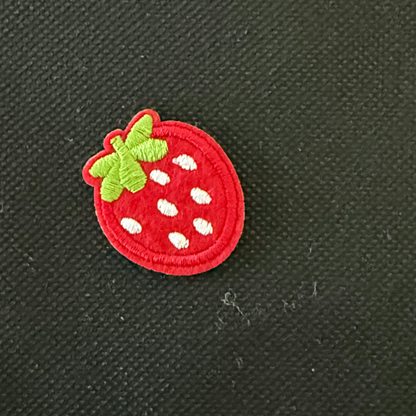 Embroidered strawberry patch on a black background