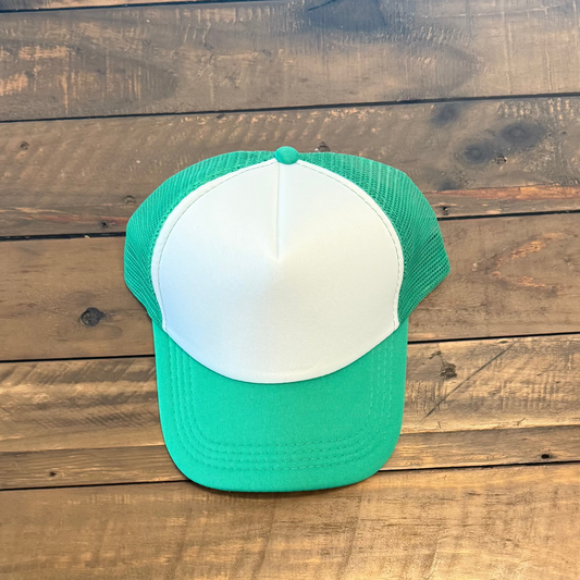 Green and white cap on a wooden surface