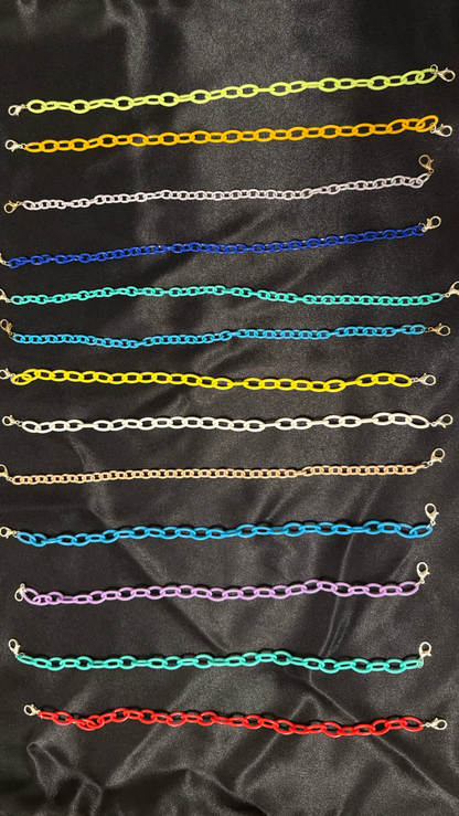Collection of colorful chain necklaces on a black satin background
