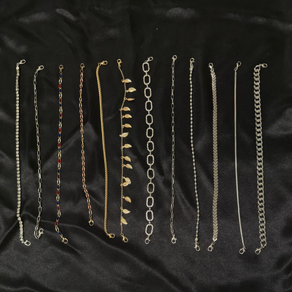 Set of various chain necklaces on a black fabric background