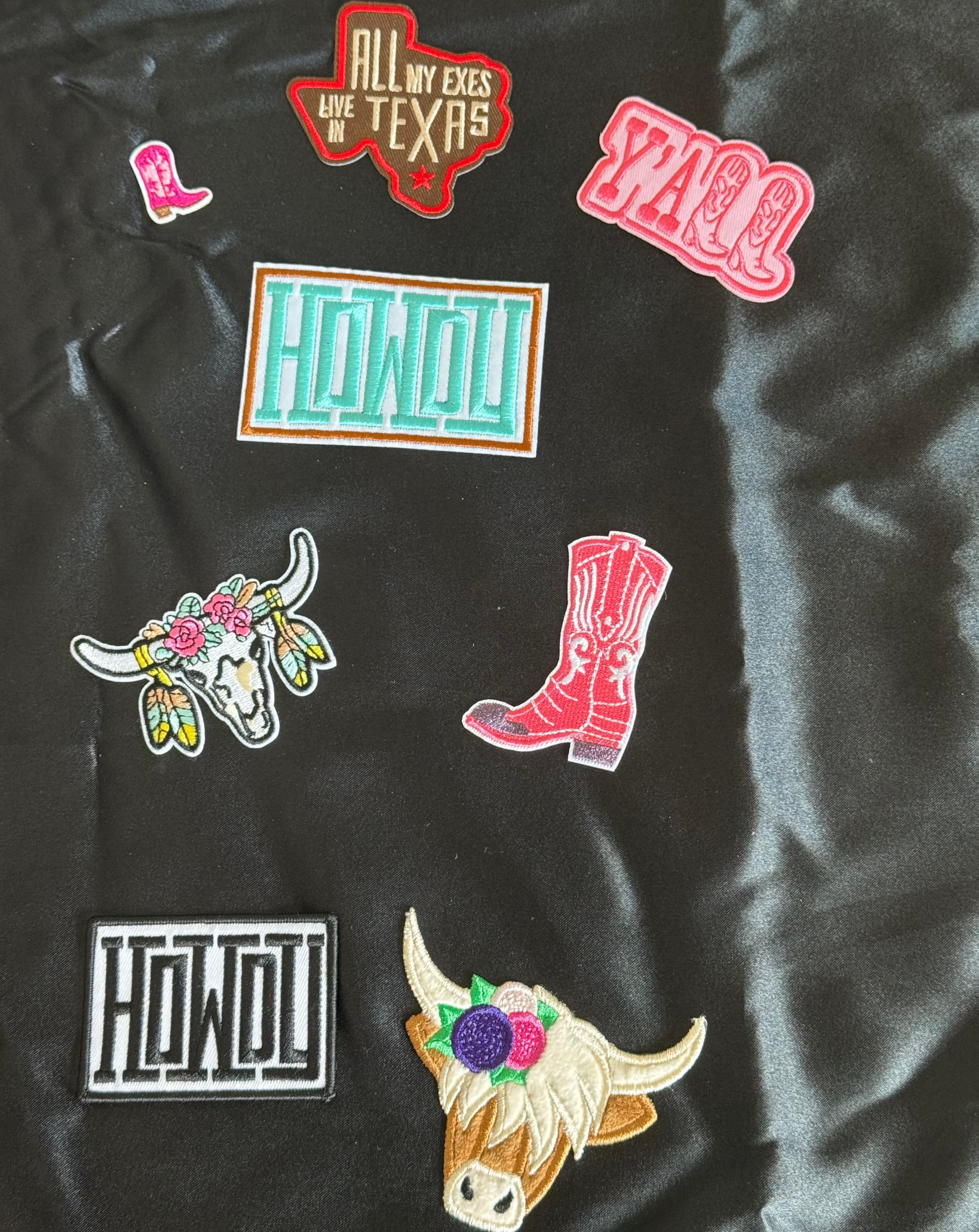 Collection of colorful cowboy and cowgirl patches on a black background